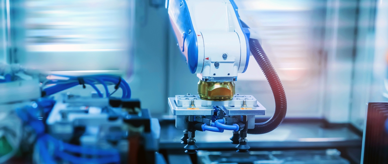 Industrial robotic arm with a gripper operating on a high-speed manufacturing line.