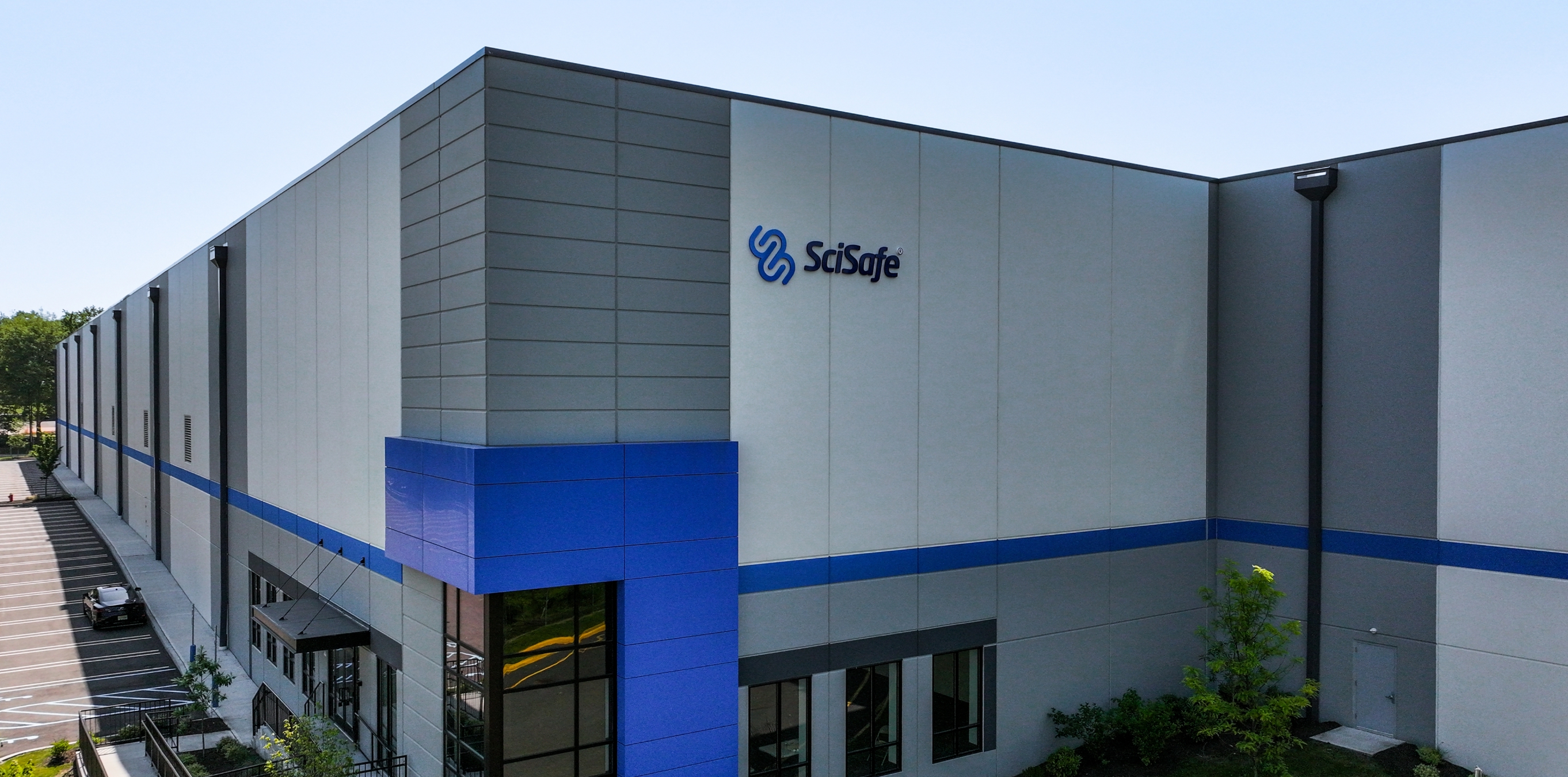 SciSafe warehouse and office building exterior with blue accent stripe.