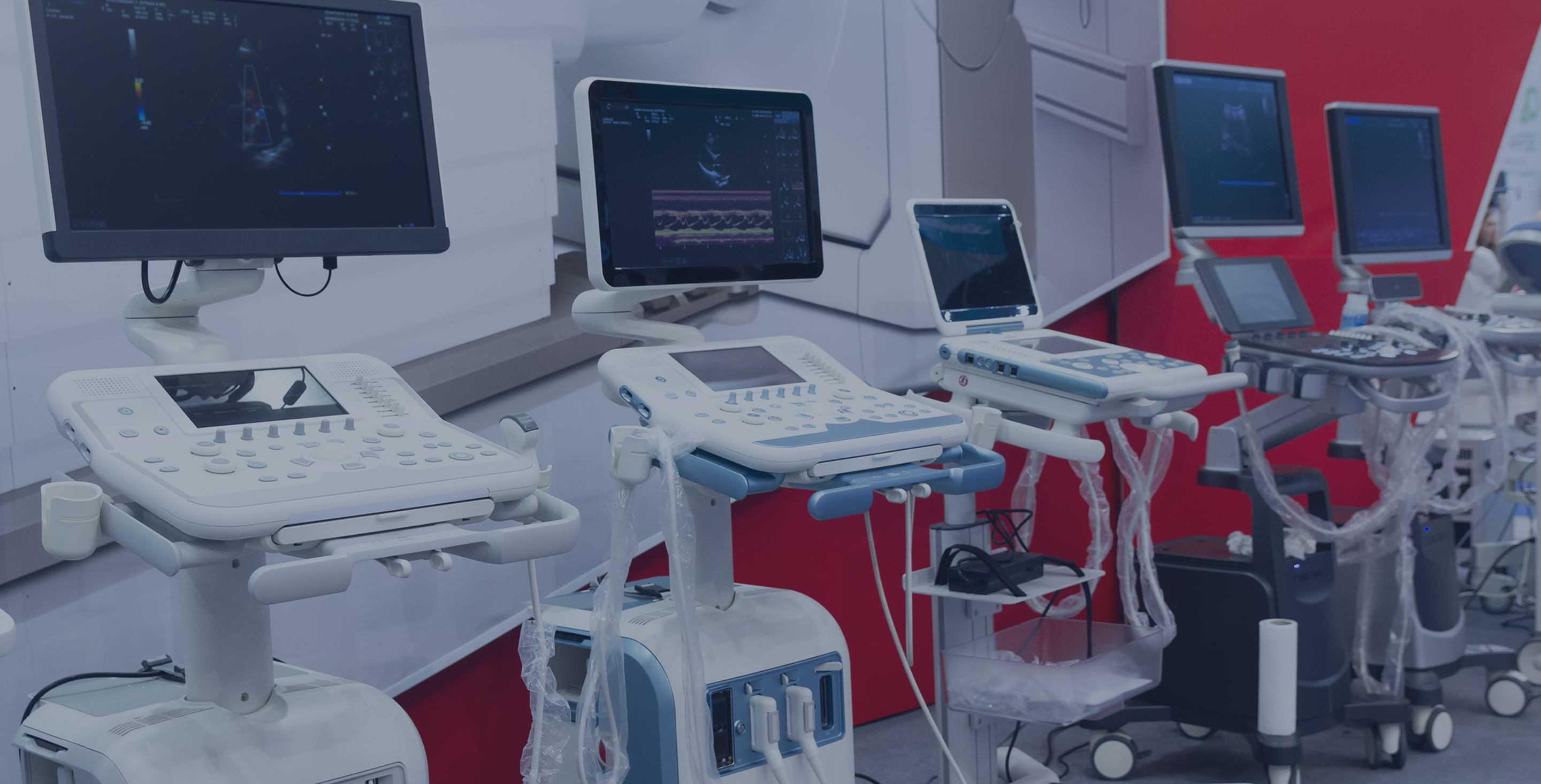 Row of ultrasound machines on wheeled carts displayed in a medical equipment showroom.