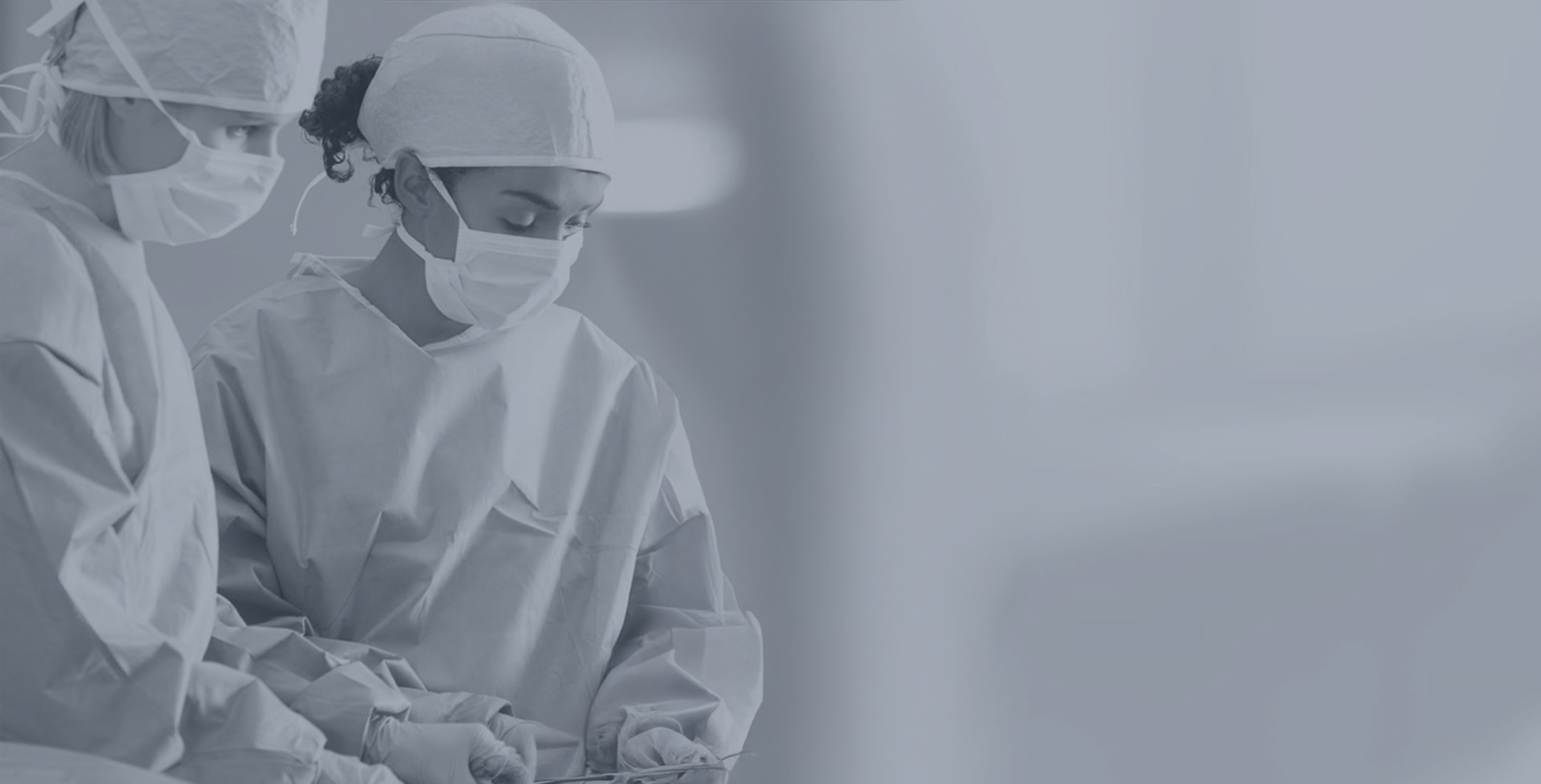 Surgical team in protective gowns and masks preparing for a procedure.